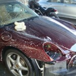Before and after photographs of a damaged Porsche that was repaired by Elite Paint & Body Shop in West Palm Beach, Florida.